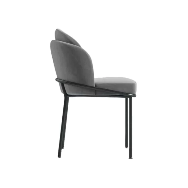 Modern metal dining room chair with a minimalist frame, straight backrest, and slim legs, placed beside a dining table